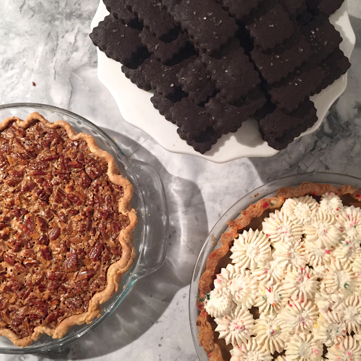 {Desserts from last week's meal: Cook's Illustrated pecan pie, my mom's funfetti pumpkin pie, Miette's chocolate sables}