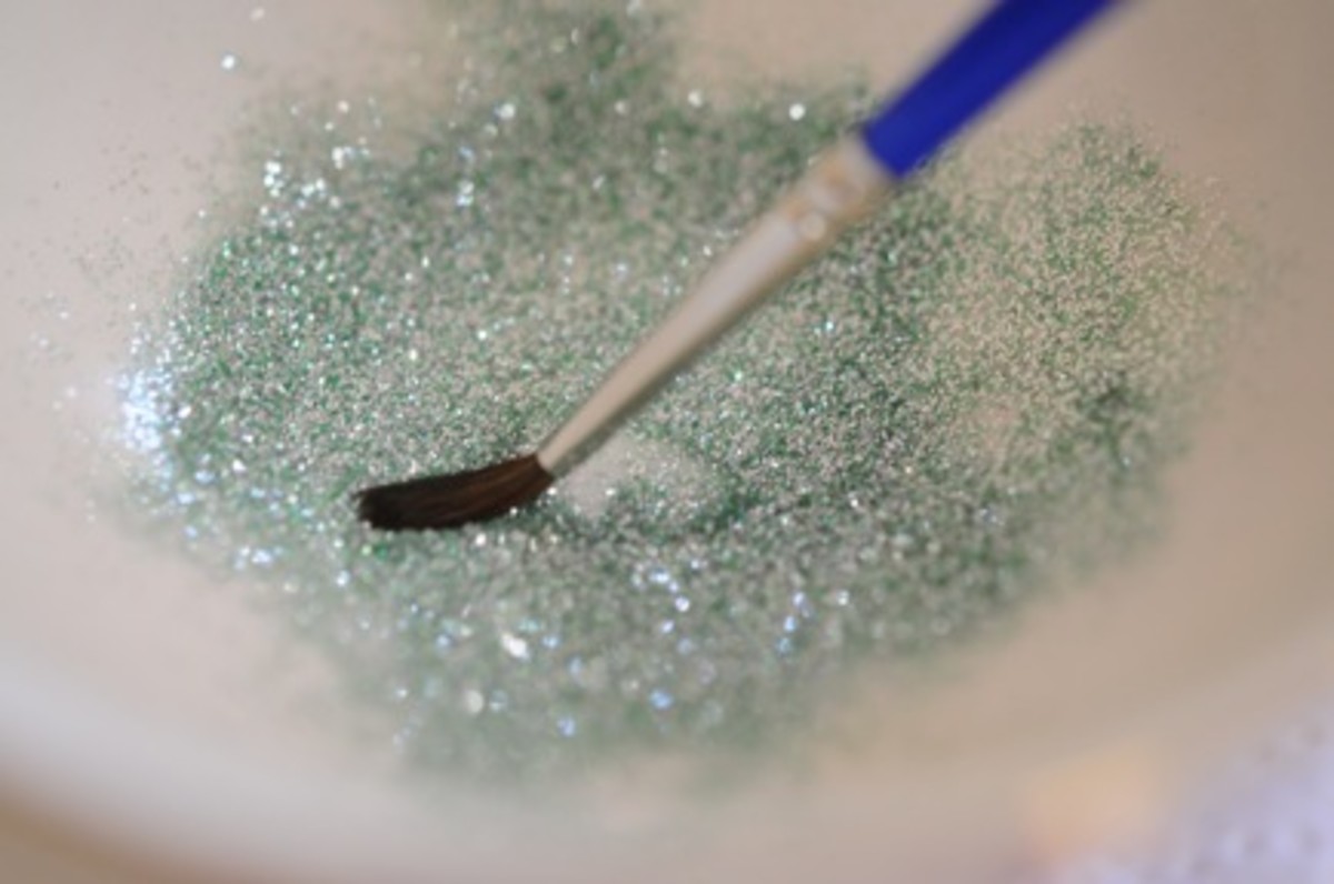 {Dip a separate brush into top coat and then into the glitter}