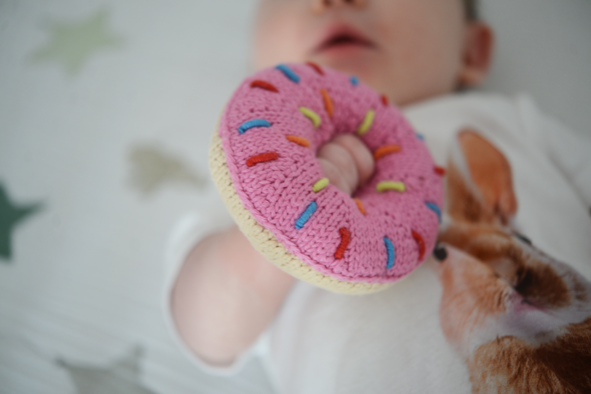 {Sloan shares our appreciation for donuts with her rattle}