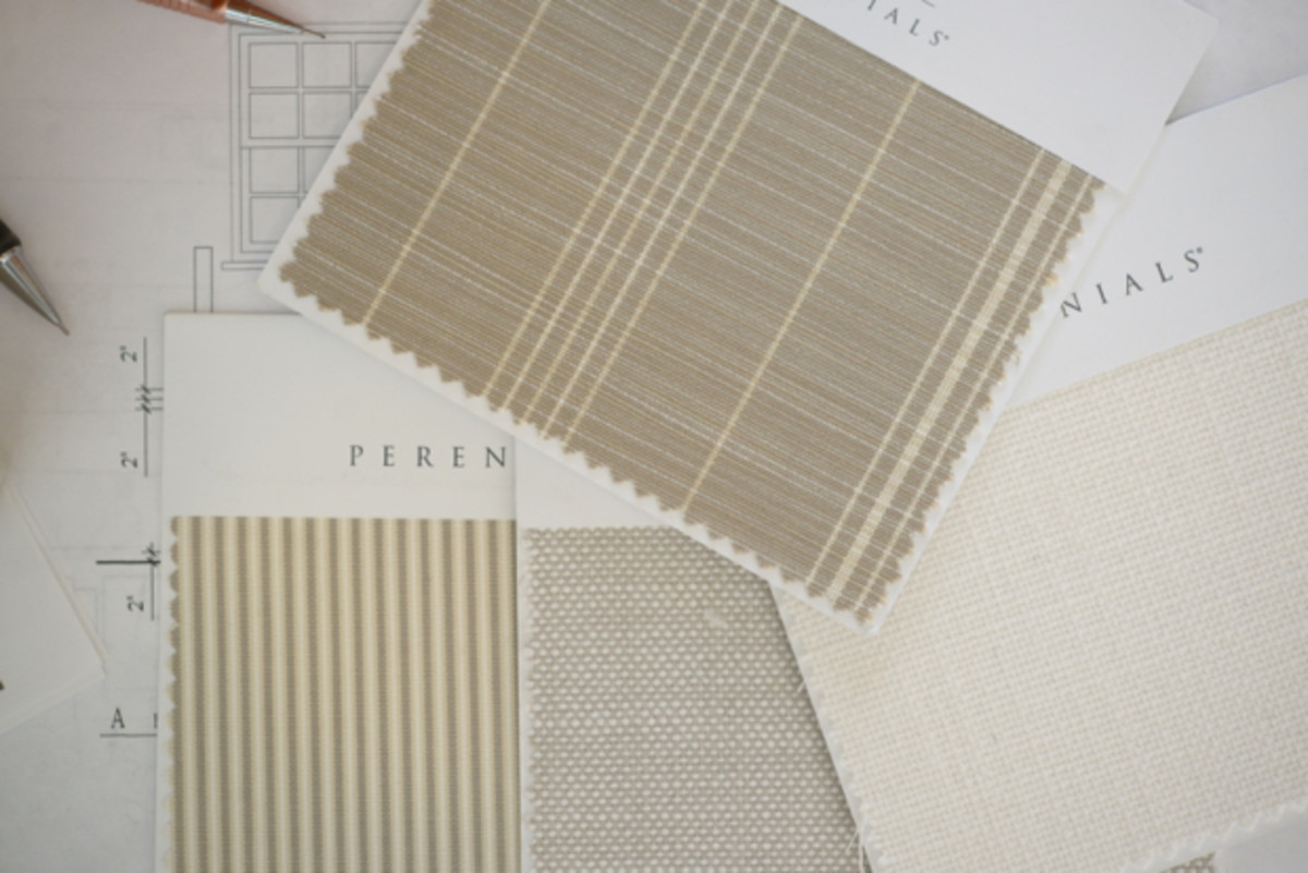 Reviewing neutral fabric swatches for our outdoor sectional