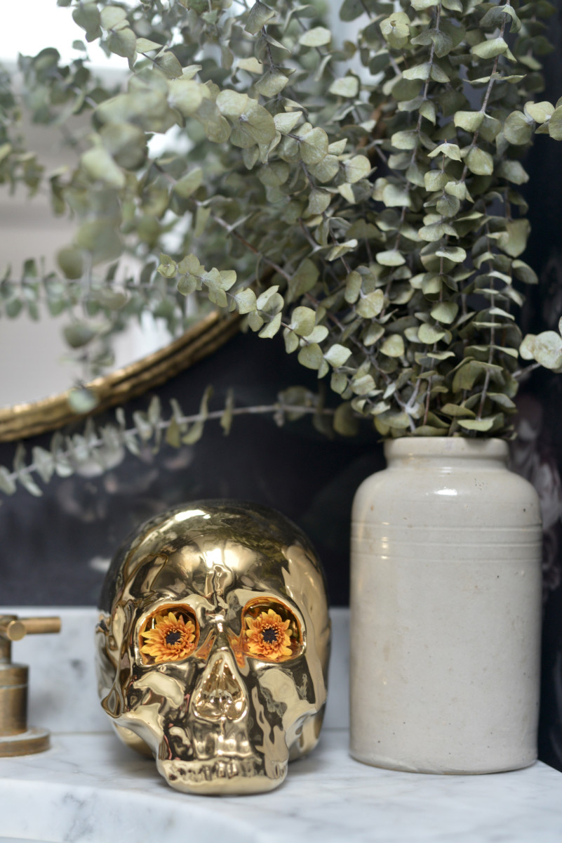 {Flowery eyes decorate a skull in the powder room}